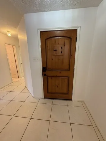 an empty room with a window and a ceiling fan