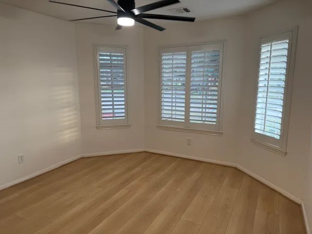 a bathroom with a granite countertop sink a mirror and a shower