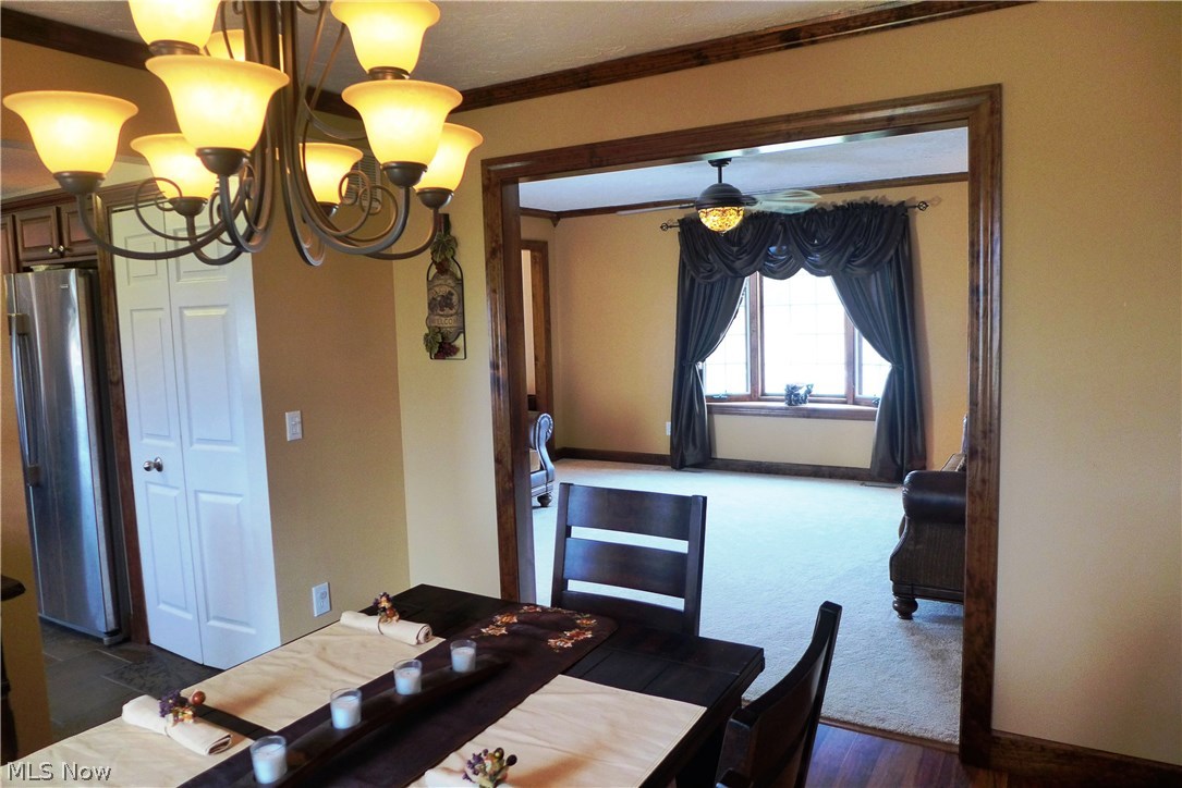 4912 South County Line Road Madison, OH 44057 - Photo 9 of 23 View from formal dining area into the large front living room area. Lots of ceiling fans in the home keep air moving if you prefer over the Central Air. The bay window open as well to allow the breeze into the home!