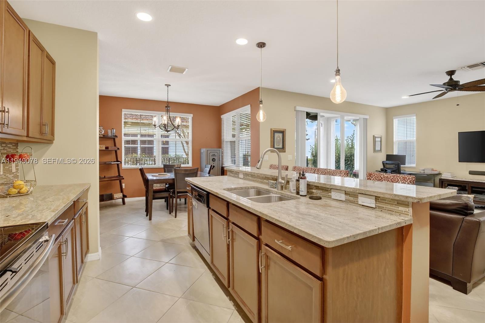 5208 Falcon Trail Davie, FL 33314 - Photo 12 of 49 a open kitchen with stainless steel appliances granite countertop a sink and a refrigerator