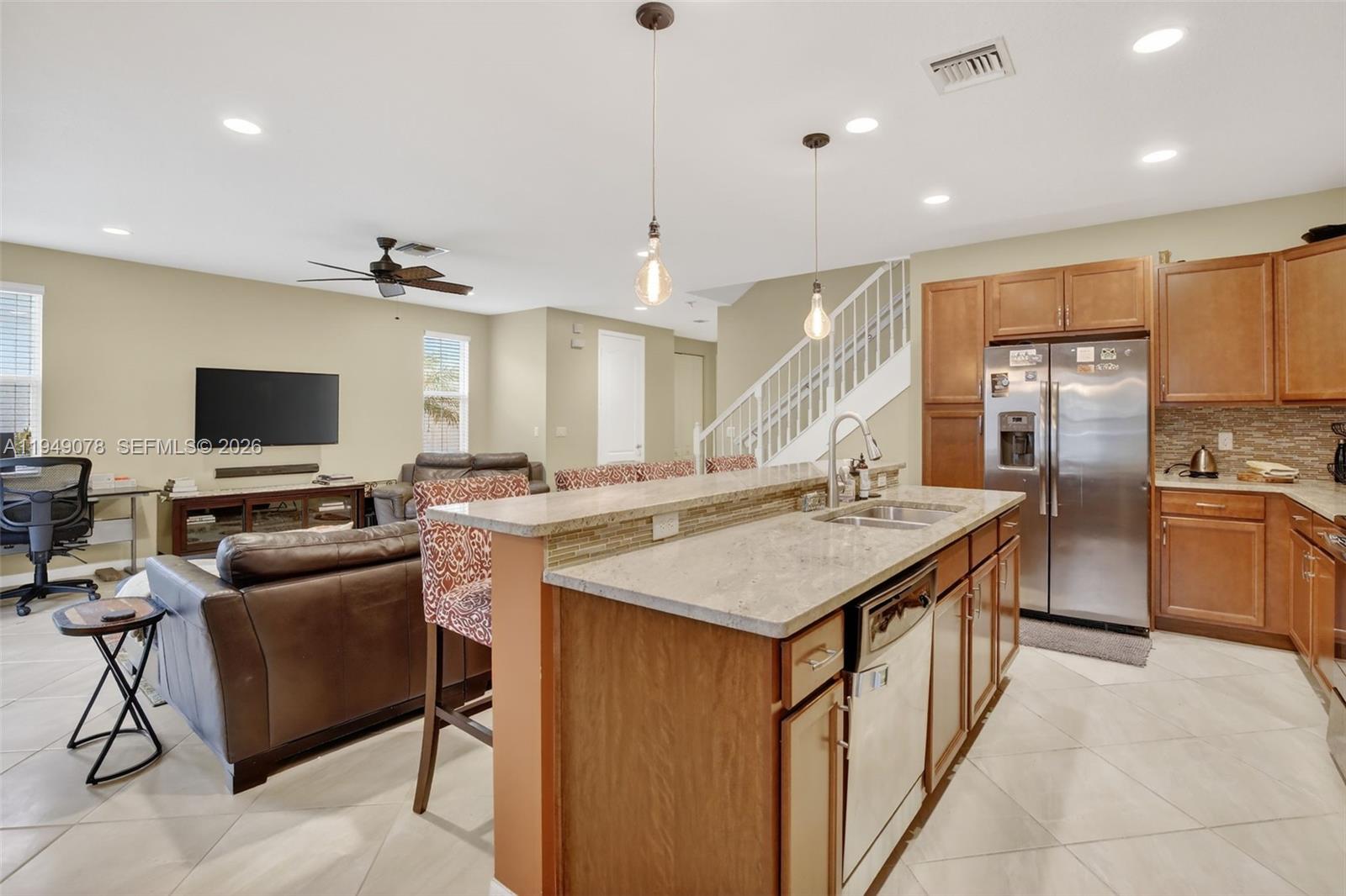 5208 Falcon Trail Davie, FL 33314 - Photo 14 of 49 a large kitchen with stainless steel appliances kitchen island granite countertop a sink and a refrigerator