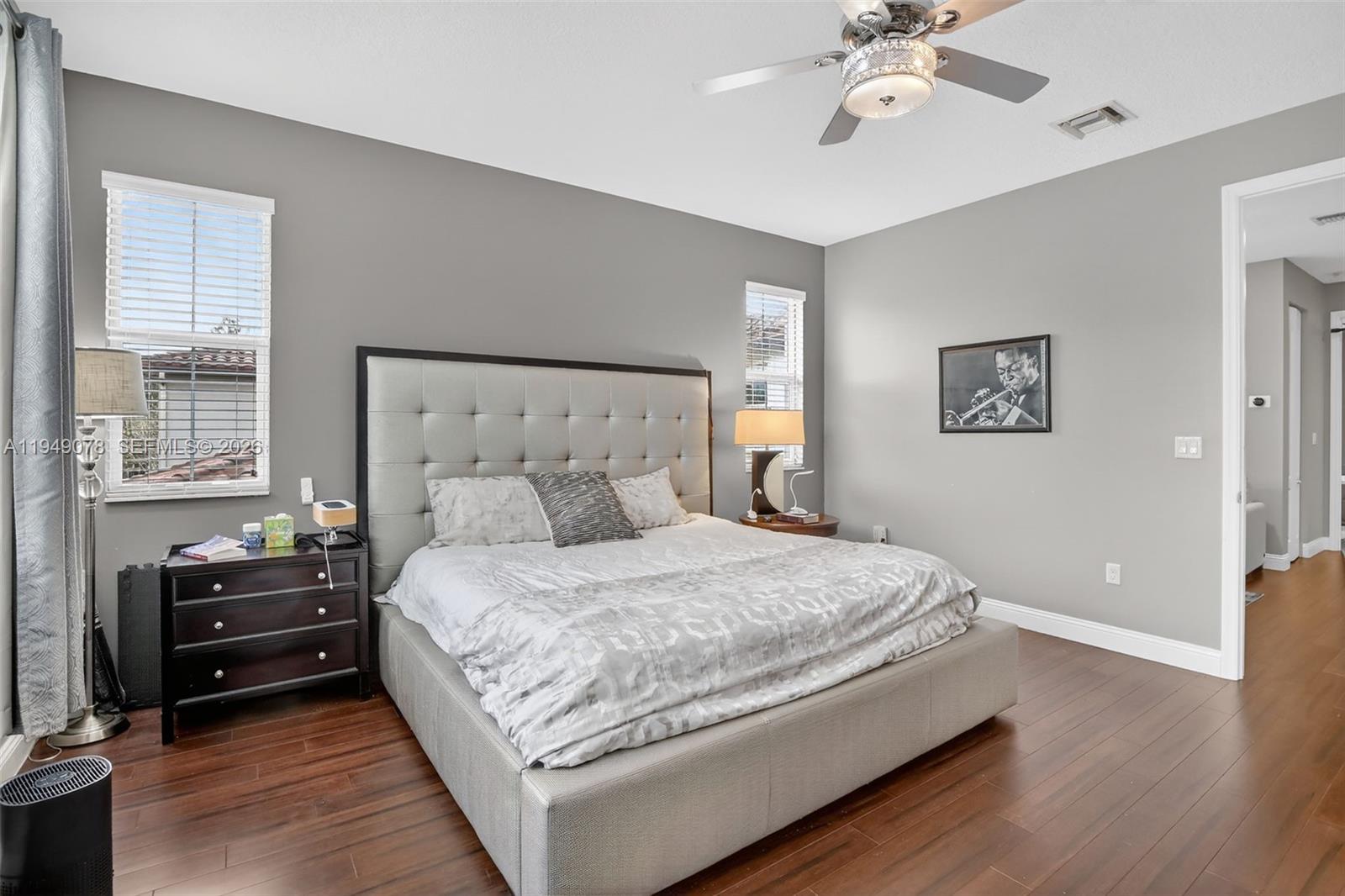 5208 Falcon Trail Davie, FL 33314 - Photo 20 of 49 a bedroom with a bed and a chandelier
