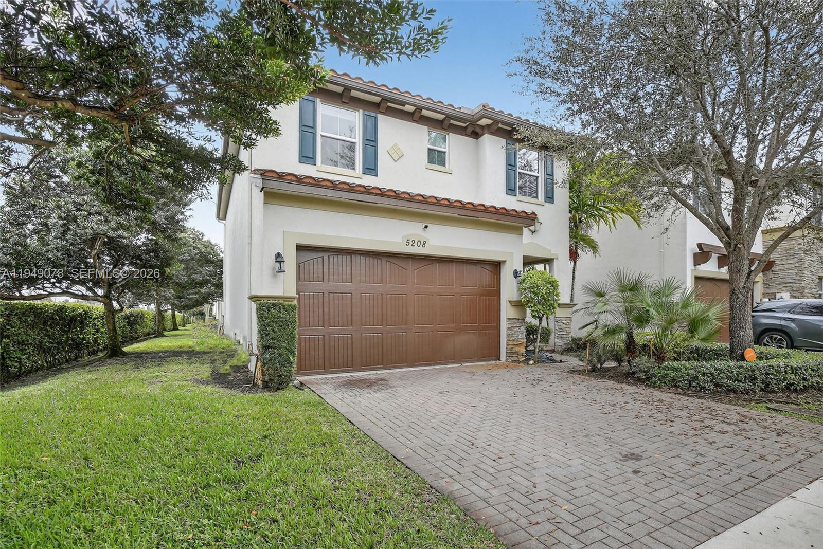 5208 Falcon Trail Davie, FL 33314 - Photo 2 of 49 a front view of a house with a yard and garage
