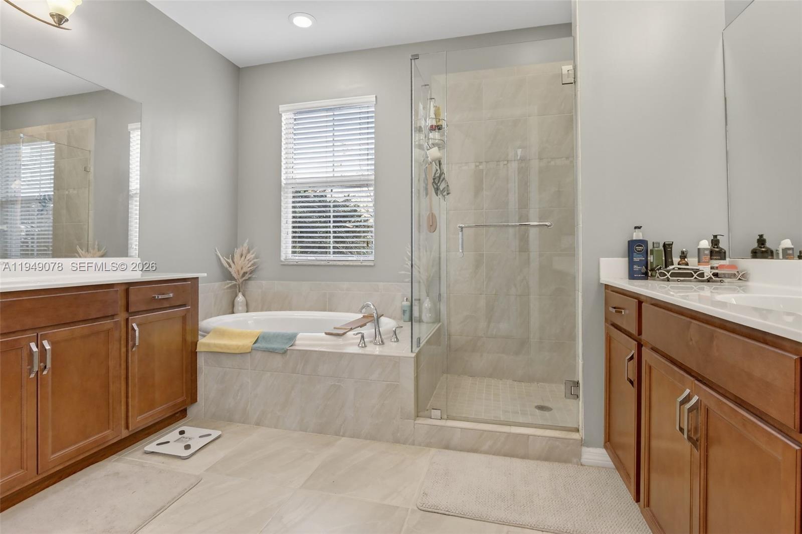 5208 Falcon Trail Davie, FL 33314 - Photo 23 of 49 a bathroom with a granite countertop bathtub sink vanity and mirror
