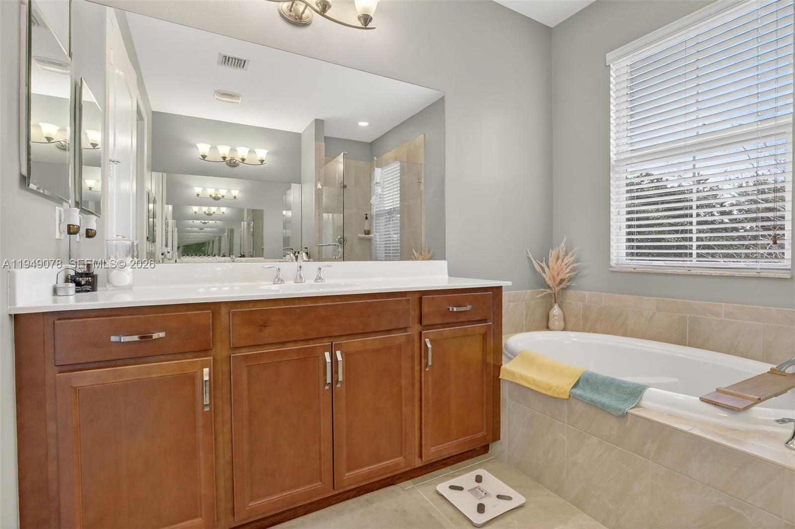 5208 Falcon Trail Davie, FL 33314 - Photo 24 of 49 a bathroom with a granite countertop sink mirror and a bathtub