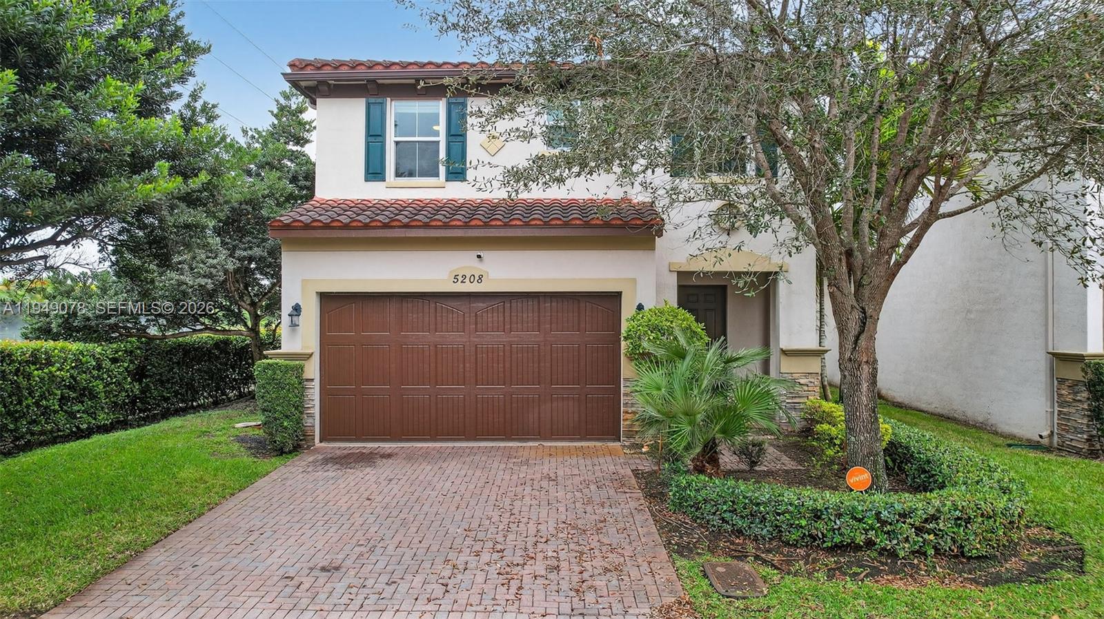 5208 Falcon Trail Davie, FL 33314 - Photo 40 of 49 a front view of a house with a yard and garage