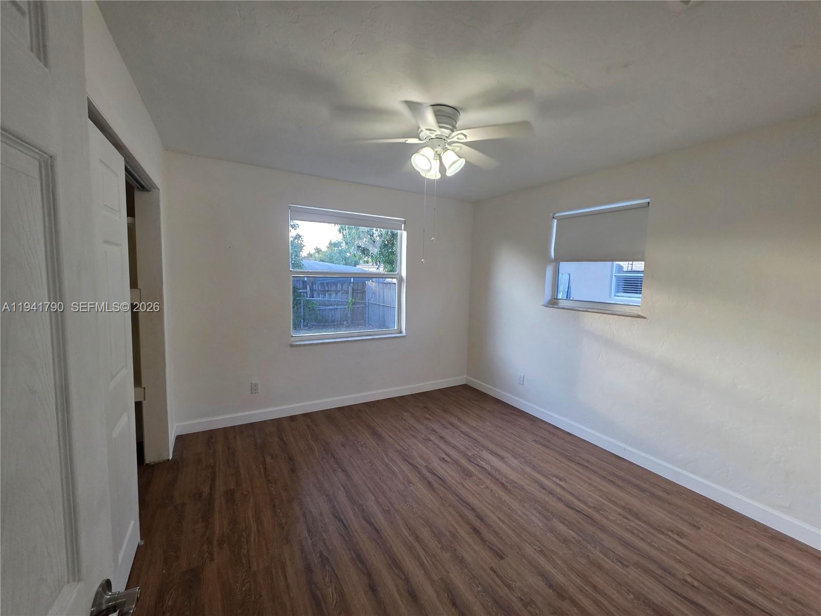 4310 East 9th Lane Hialeah, FL 33013 - Photo 12 of 21 a view of an empty room with wooden floor and a window