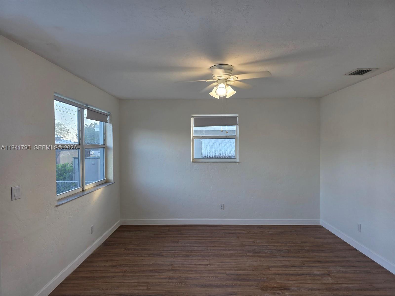 4310 East 9th Lane Hialeah, FL 33013 - Photo 5 of 21 a view of empty room with wooden floor and fan