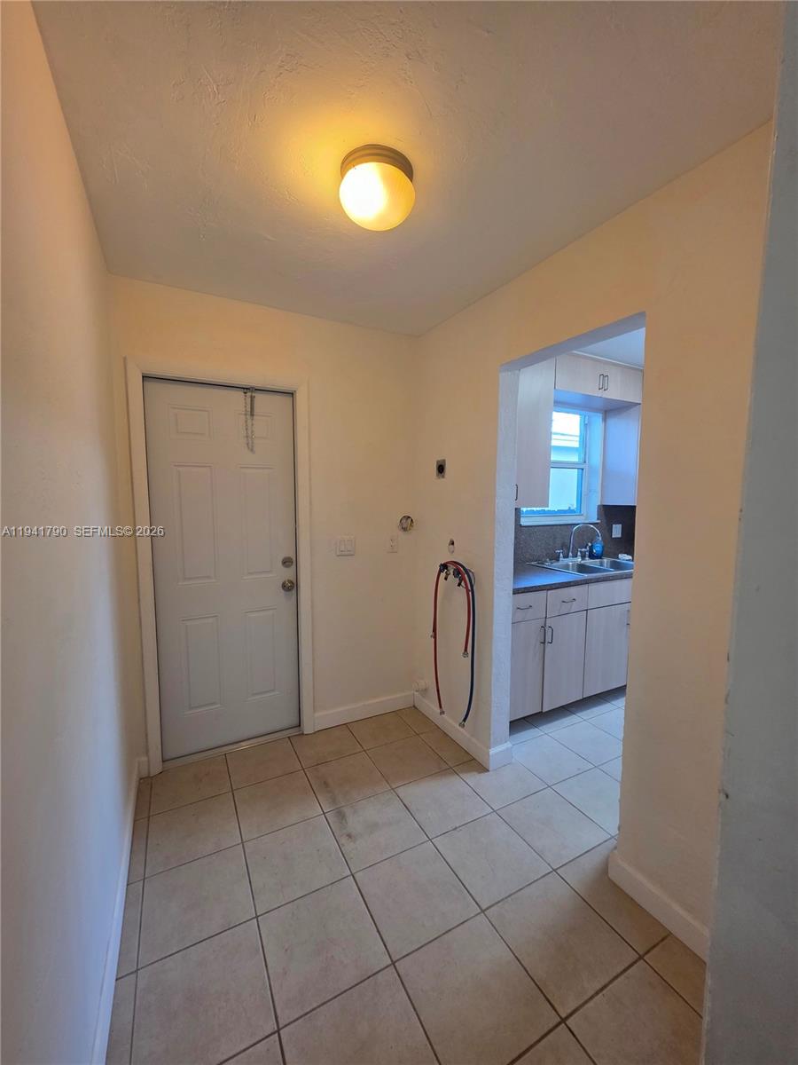 4310 East 9th Lane Hialeah, FL 33013 - Photo 9 of 21 a view of a bathroom with a sink and a mirror