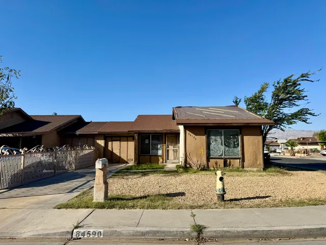 a front view of a house with parking space