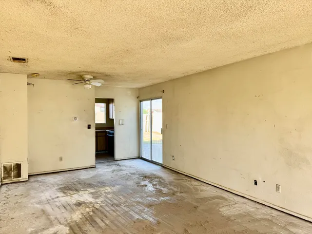 a view of a big room with wooden floor and windows