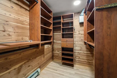 a view of walk in closet and empty room