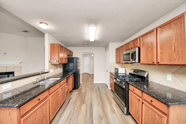 a kitchen with stainless steel appliances granite countertop counter space a sink and cabinets
