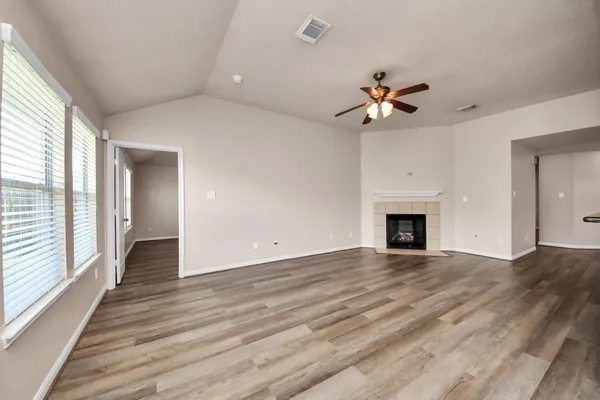 wooden floor in an empty room with a fireplace