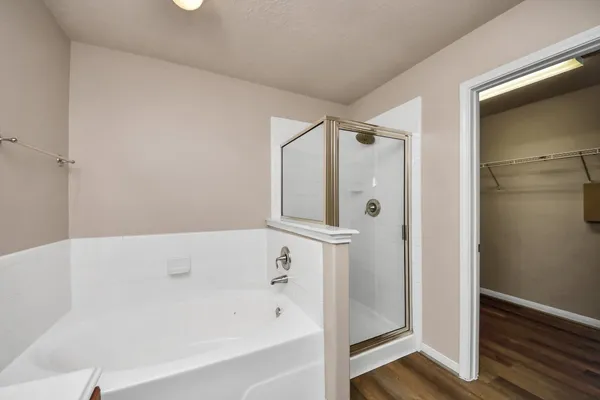 a bathroom with a bathtub and a shower
