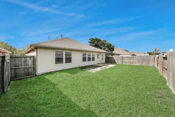 a yellow house with a garden