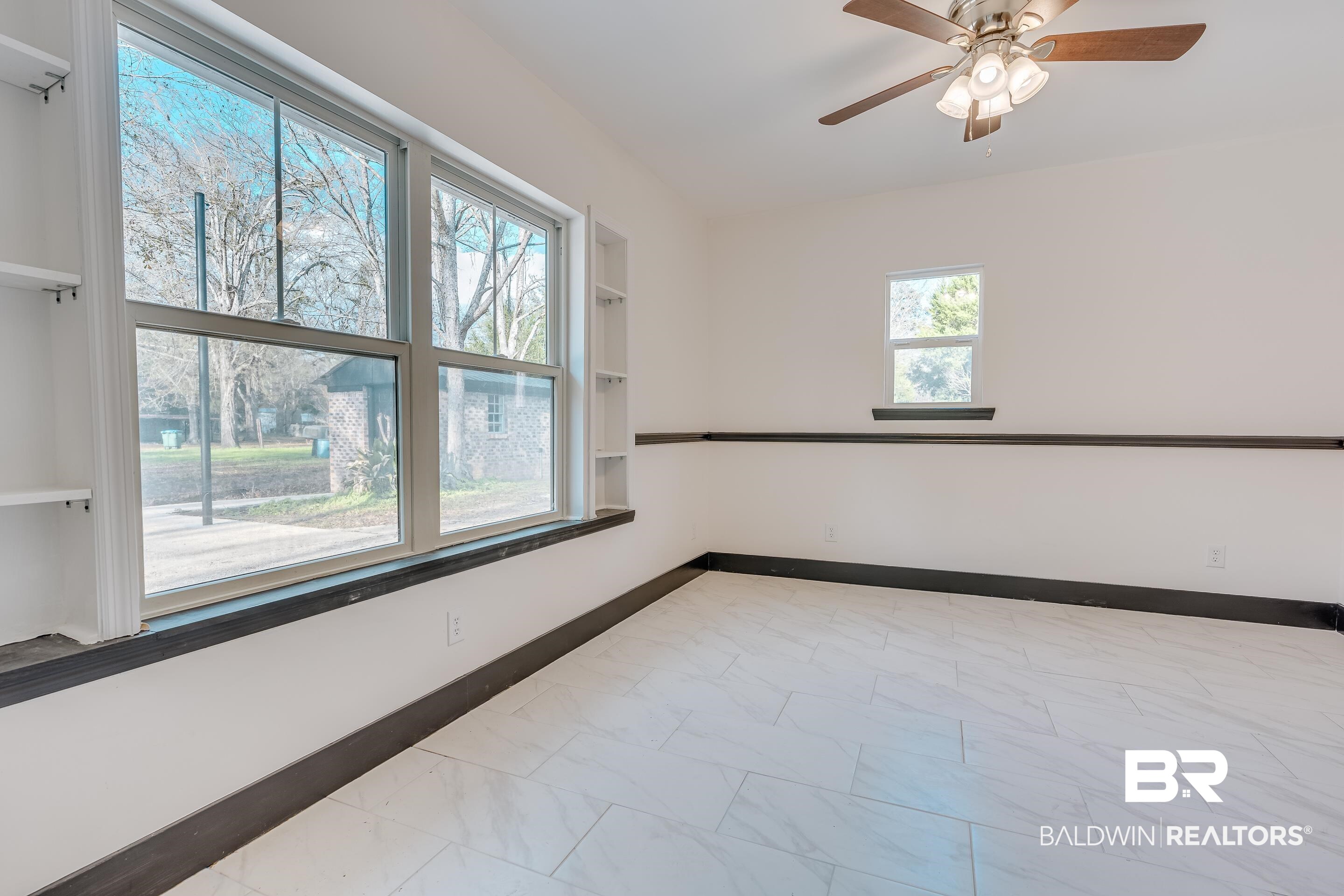 1190 Military Road Mount Vernon, AL 36560 - Photo 30 of 47 Spare room featuring ceiling fan and light marble finish flooring