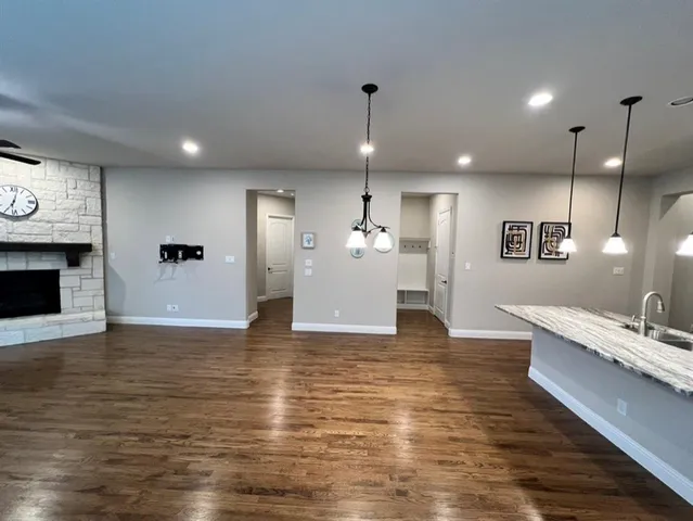 a view of a living room a kitchen and a wooden floor