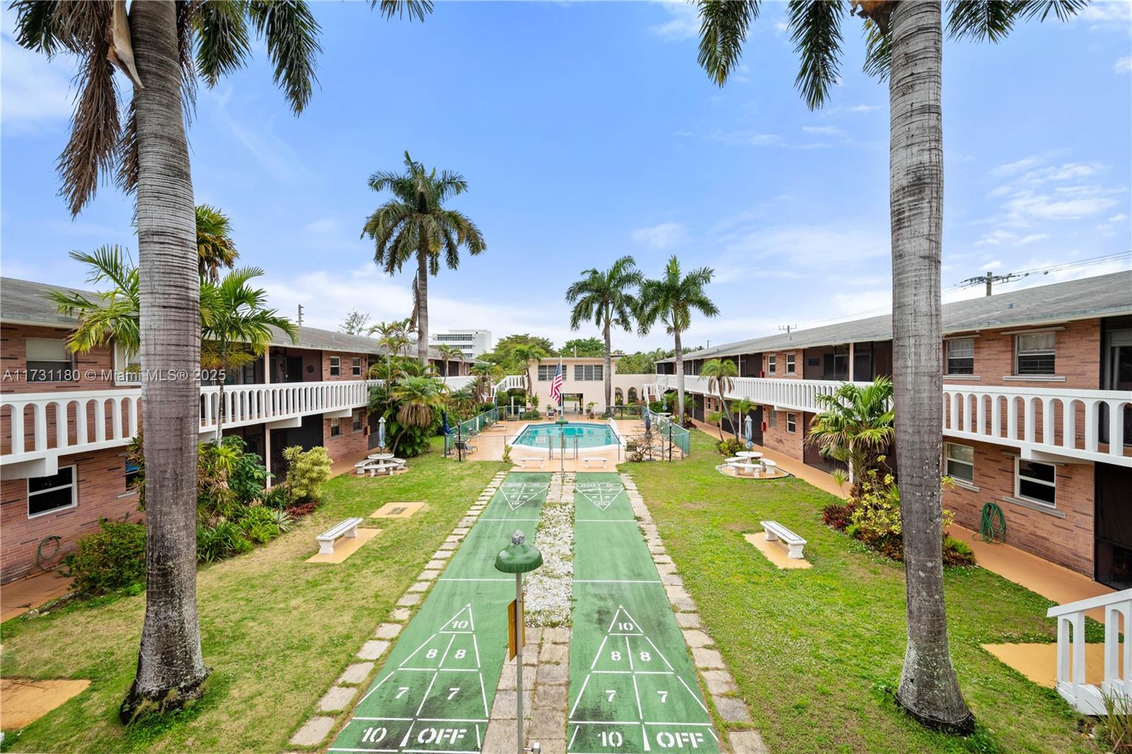 160 Northeast 8th Avenue, Unit 9B Hallandale Beach, FL 33009 - Photo 18 of 25 a view of a swimming pool with a garden