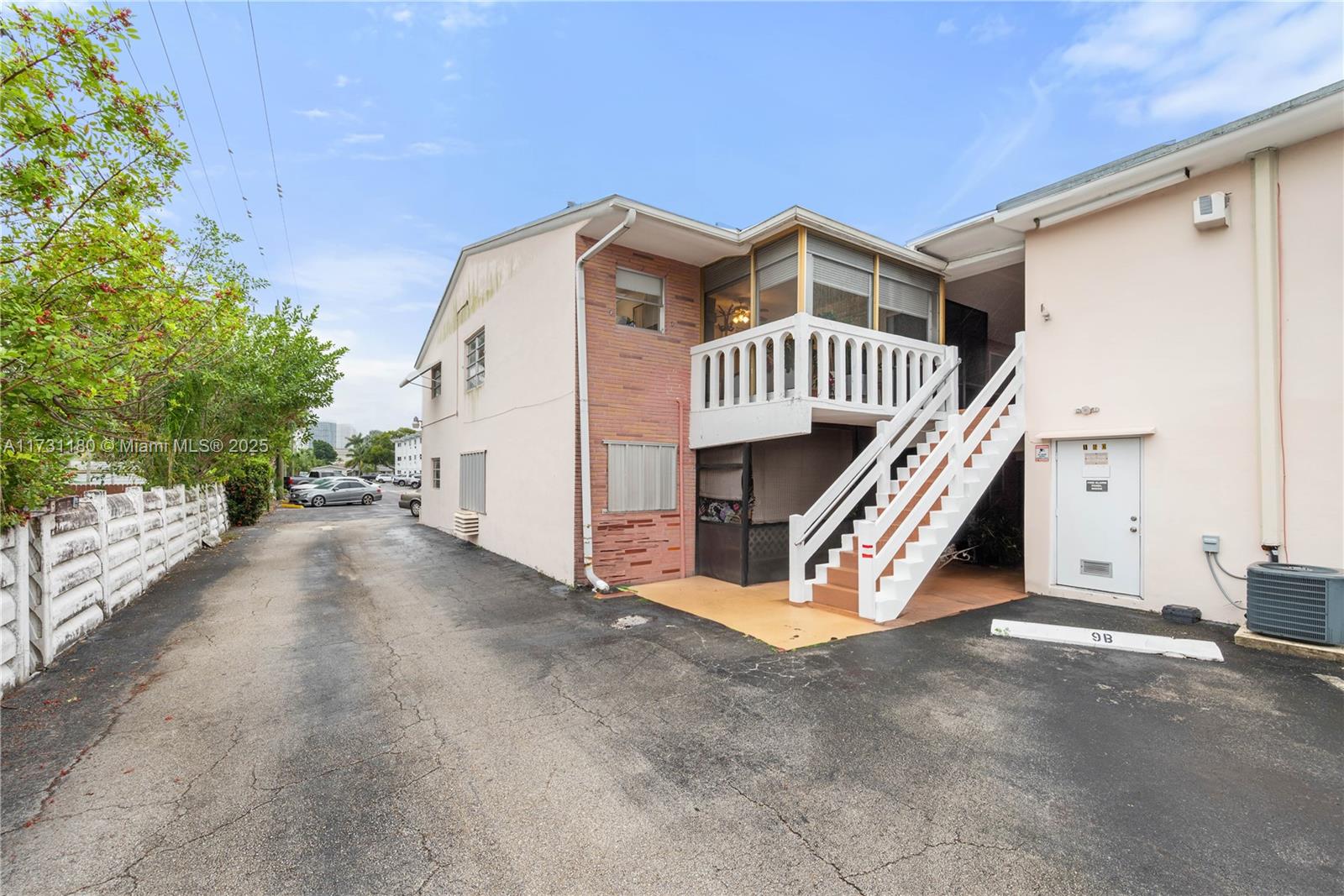 160 Northeast 8th Avenue, Unit 9B Hallandale Beach, FL 33009 - Photo 21 of 25 a view of a house with a yard and deck