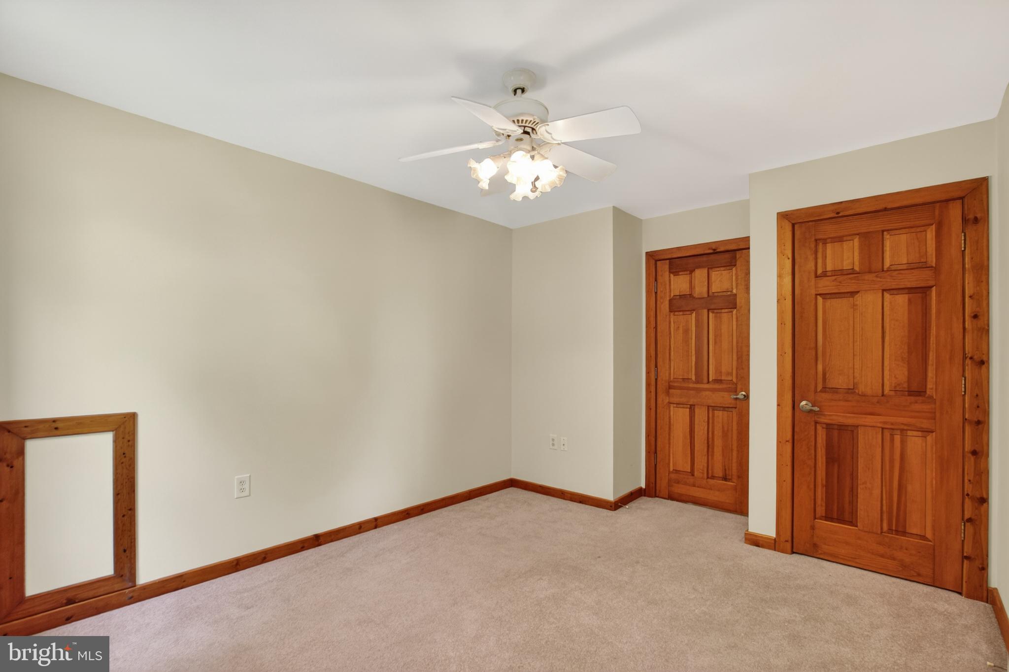 14575 Honeysuckle Way Issue, MD 20645 - Photo 27 of 49 an empty room with windows and ceiling fan