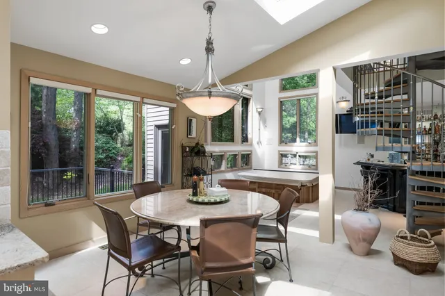 a kitchen with a dining table and chairs