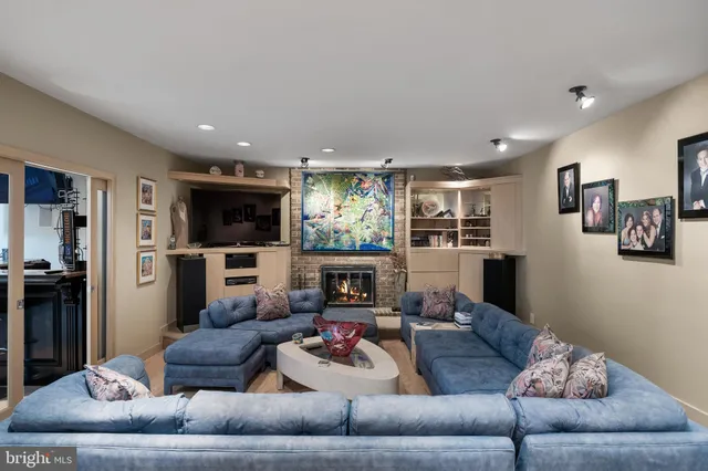 a living room with furniture and a view of kitchen