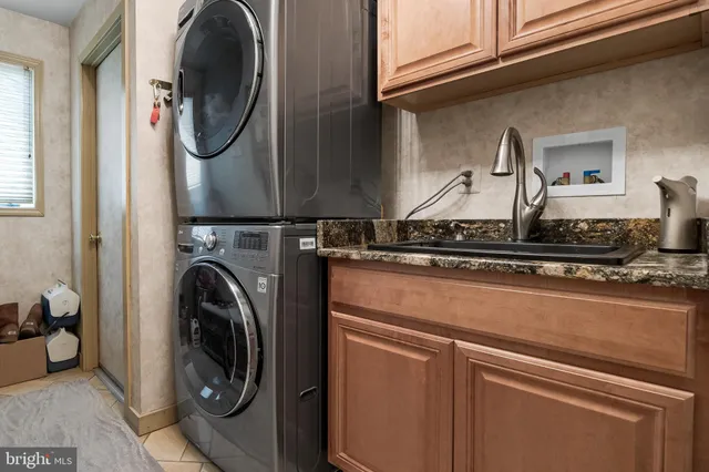 a bedroom with a large bed a flat tv screen and a chandelier