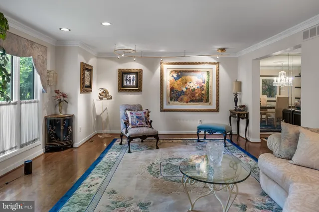 a living room with furniture wooden floor and a flat screen tv