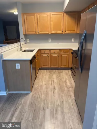 a kitchen with stainless steel appliances granite countertop a sink a stove and a refrigerator