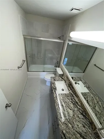 a kitchen with stainless steel appliances granite countertop a refrigerator a stove a sink and a microwave