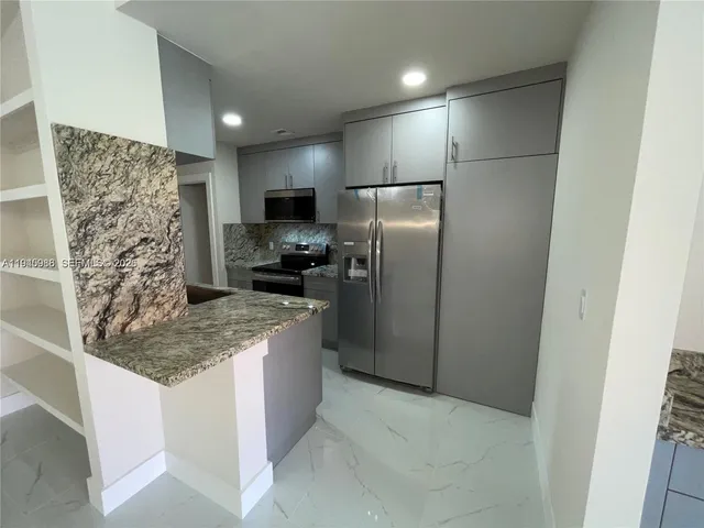 a kitchen with a stove and a refrigerator