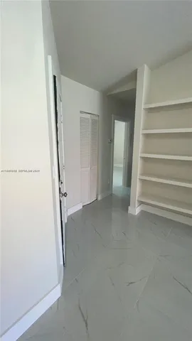 a kitchen with granite countertop a stove and cabinets