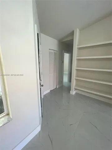 a view of room with closet and empty racks