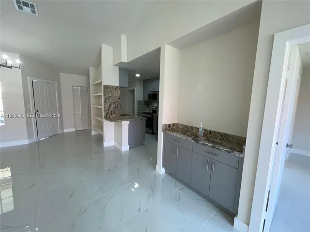 a kitchen with a refrigerator and sink