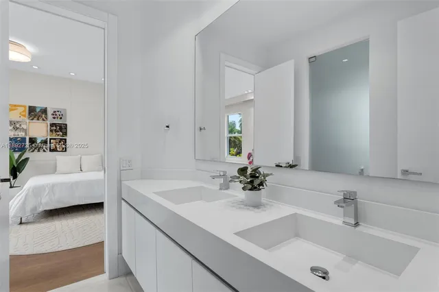 a bedroom with a bed and a dresser next to a wooden floor