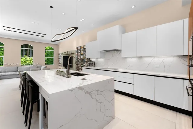 a kitchen with a sink a table and chairs in it