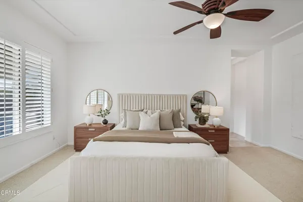 a large white room with a large mirror and a sink