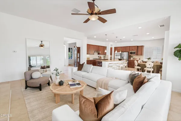 a large white kitchen with stainless steel appliances kitchen island granite countertop a sink and cabinets