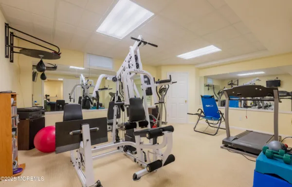 an aerial view of a houses with a yard and lake view