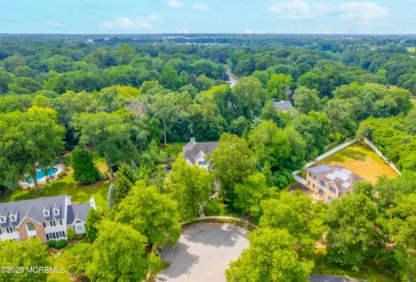 an aerial view of residential house with swimming pool