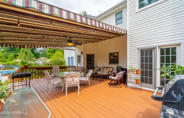 a front view of a house with a yard and trees
