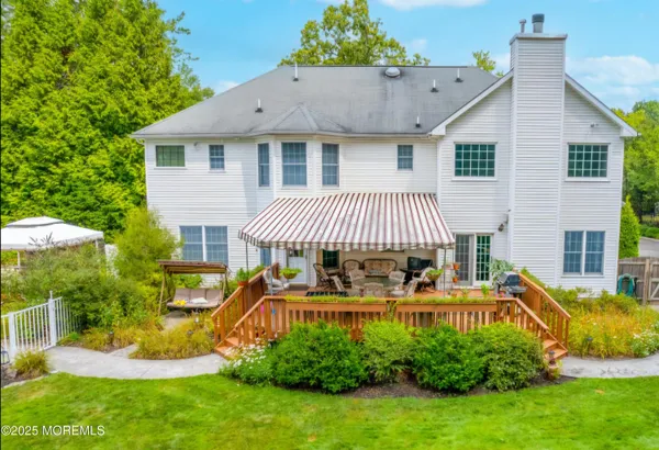 a view of backyard with house and green space