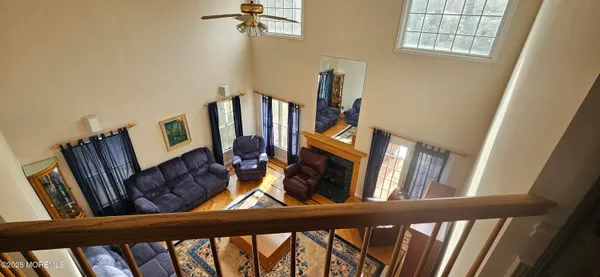 a living room with a baby crib and a wooden floor