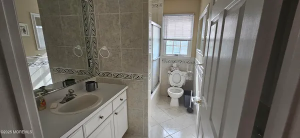 a bedroom with two beds and painting on the wall