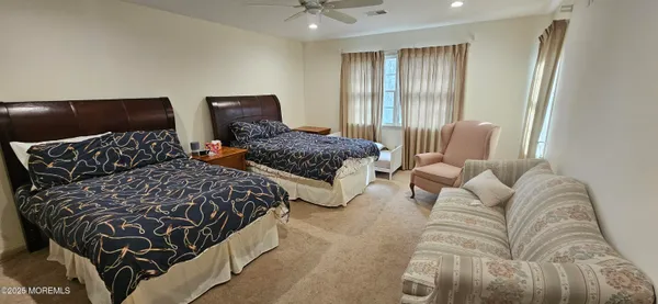 a bed sitting in a bedroom next to a window