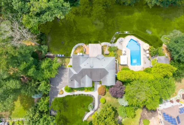 an aerial view of a house with a swimming pool and garden view