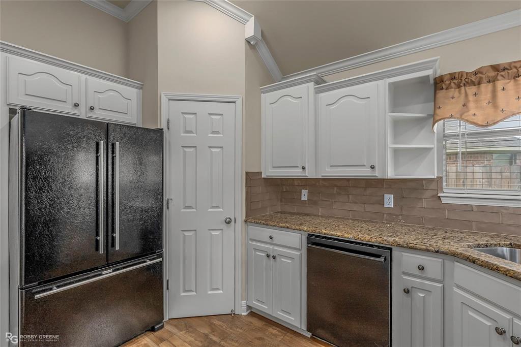 2186 Stockwell Road Bossier City, LA 71111 - Photo 12 of 40 Kitchen with freestanding refrigerator, white cabinetry, dishwasher, ornamental molding, and light wood-style floors
