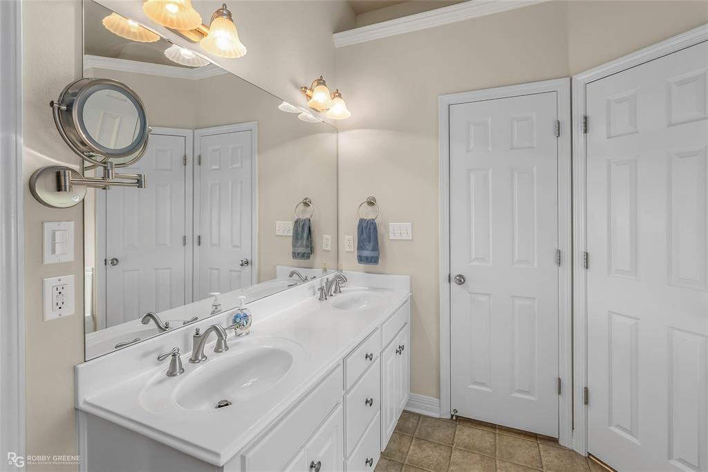 2186 Stockwell Road Bossier City, LA 71111 - Photo 16 of 40 Full bathroom with double vanity, ornamental molding, and light tile patterned floors