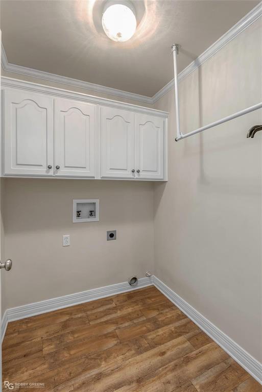 2186 Stockwell Road Bossier City, LA 71111 - Photo 23 of 40 Laundry area with crown molding, dark wood finished floors, cabinet space, washer hookup, and electric dryer hookup